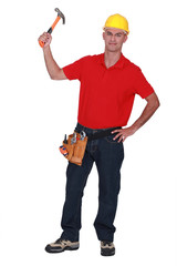 Young handyman raising hammer in the air