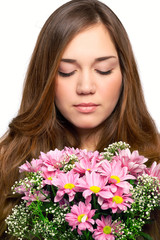 Naklejka premium portrait of a beautiful girl with luxurious long hair and a pink