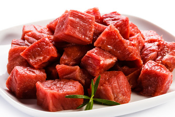 Raw beef and vegetables on white background
