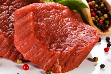 Raw beef and vegetables on white background