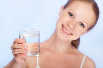 young healthy woman and a glass of clean water