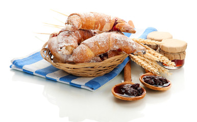 Taste croissants in basket and jam isolated on white.