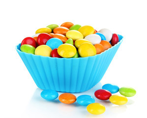 Colorful candies in cupcake case isolated on white