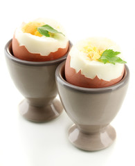 Boiled eggs in egg cup, isolated on white