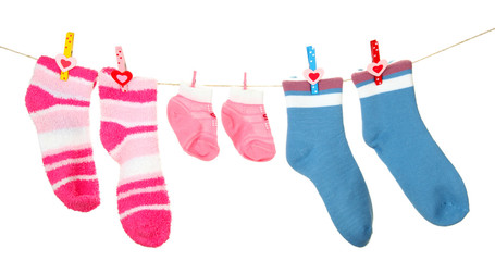 Colorful socks hanging on clothesline, isolated on white
