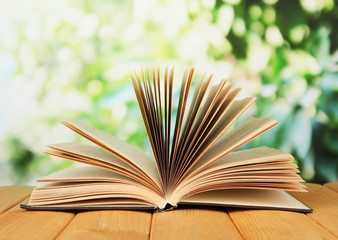 Opened book on bright background