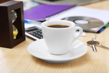 Cup of coffee on office desktop close-up