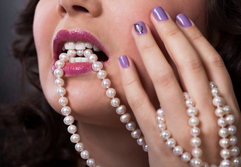 Beautiful Young Woman Holding Pearl Necklace