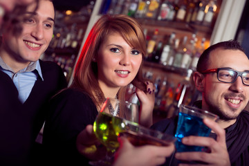 friends toasting at the disco