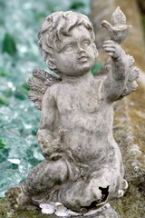 stone cherub angel gravestone at cemetery