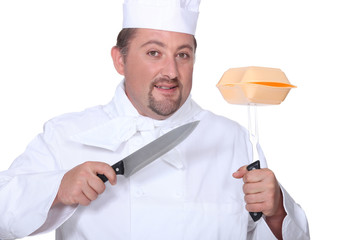 Professional cook holding knives and hamburger box