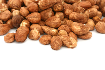 Many hazel nuts on white background