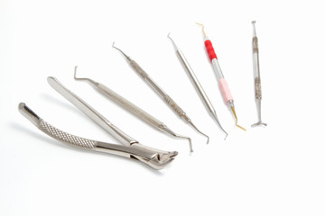  dentist extraction forceps and dental equipment on white backgr