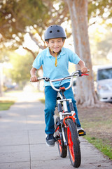 Fototapeta premium Boy Wearing Safety Helmet Riding Bike