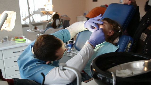 little girl in the dentist. Girl crying in pain