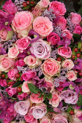 purple and pink roses wedding arrangement