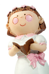 Ceramic doll reading a book