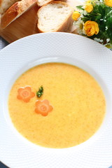 French cuisine, carrot soup and baugette,