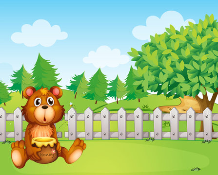 A bear inside the fence holding a pot of honey