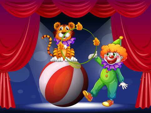 A tiger and a clown performing at the stage