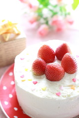 Strawberry cake decorated by heart shaped candy 