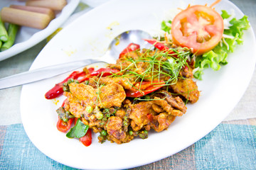Fototapeta premium Dried pork with spicy curry on white plate in restaurant