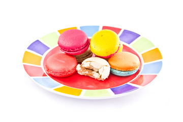 Colorful macaroons on colorful plate isolated