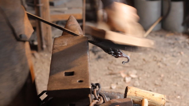 Blacksmith work. The blacksmith does arrow from metal.