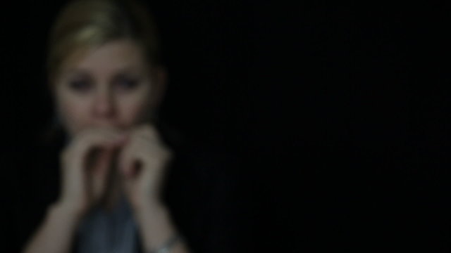 Scared shocked woman face in darkness