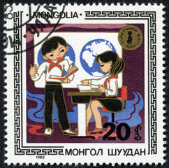 stamp printed in Mongolia showing students
