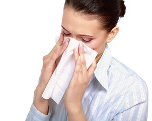 A portrait of a young woman blowing her nose