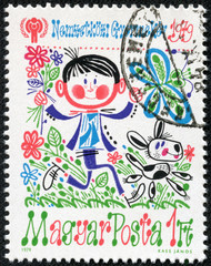 stamp printed in Hungary shows a boy with a dog and a butterfly
