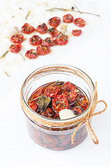 Dried cherry tomatoes with herbs and spices. Italian cuisine.