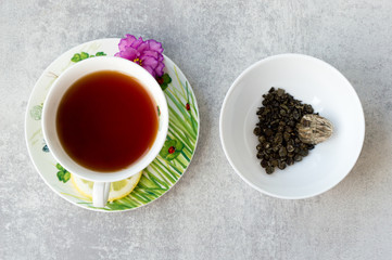 Two cups of tea on grey background