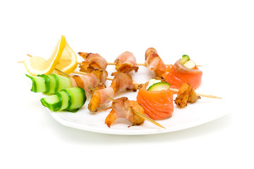 grilled shrimp with bacon and salmon rolls on white background