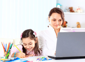 Young mother with little daughter sitting together