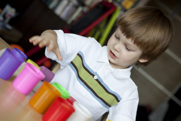 Little boy creating toys from playdough