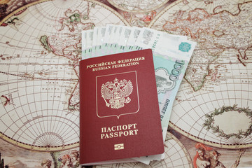 Passport and money lie on the background of the map of the world