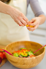 Closeup on housewife preparing vegetable salad