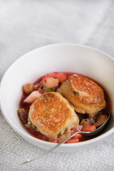 Spicy fruit cobbler in a white bowl