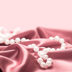 Pearls on a silk fabric background
