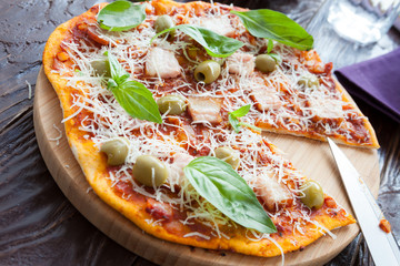 homemade thin pizza with bacon and green olives