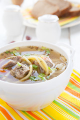 soup with meat in a white tureen