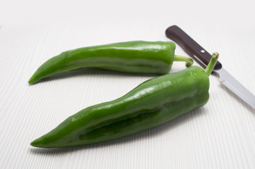 two green peppers and knife