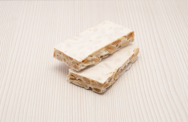Pieces of Christmas hard almond turron on white background