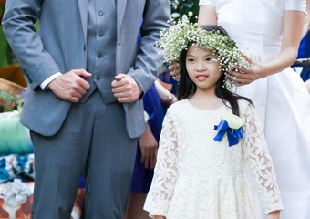 Cute little flower girl in the wedding ceremony