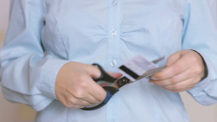 Close-up Of Woman cut a credit card in half