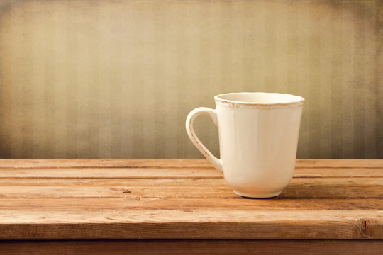 Vintage background with cup of tea on wooden table