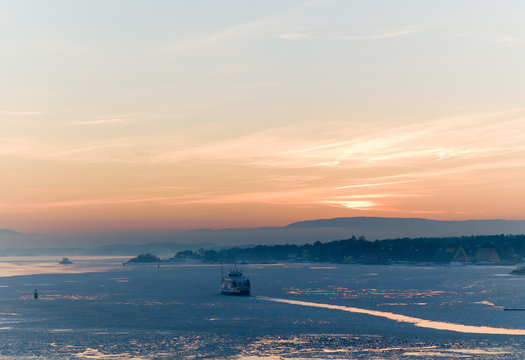 Ferry through the ice in the sunset