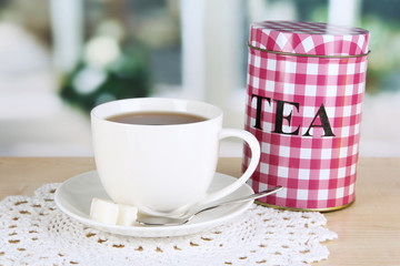 Jar and cup of tea isolated on white